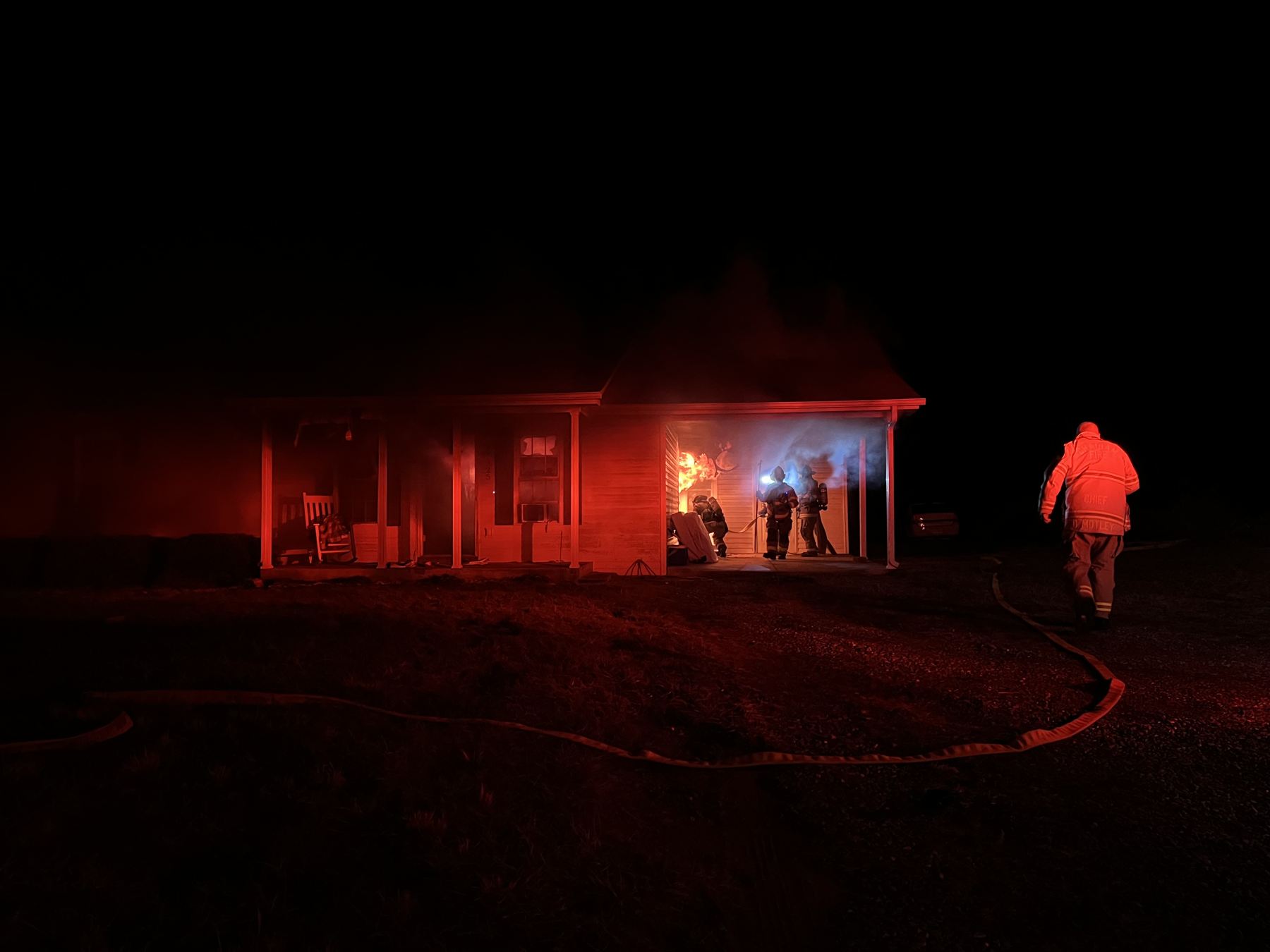 Firefighters working at a nighttime structure fire
